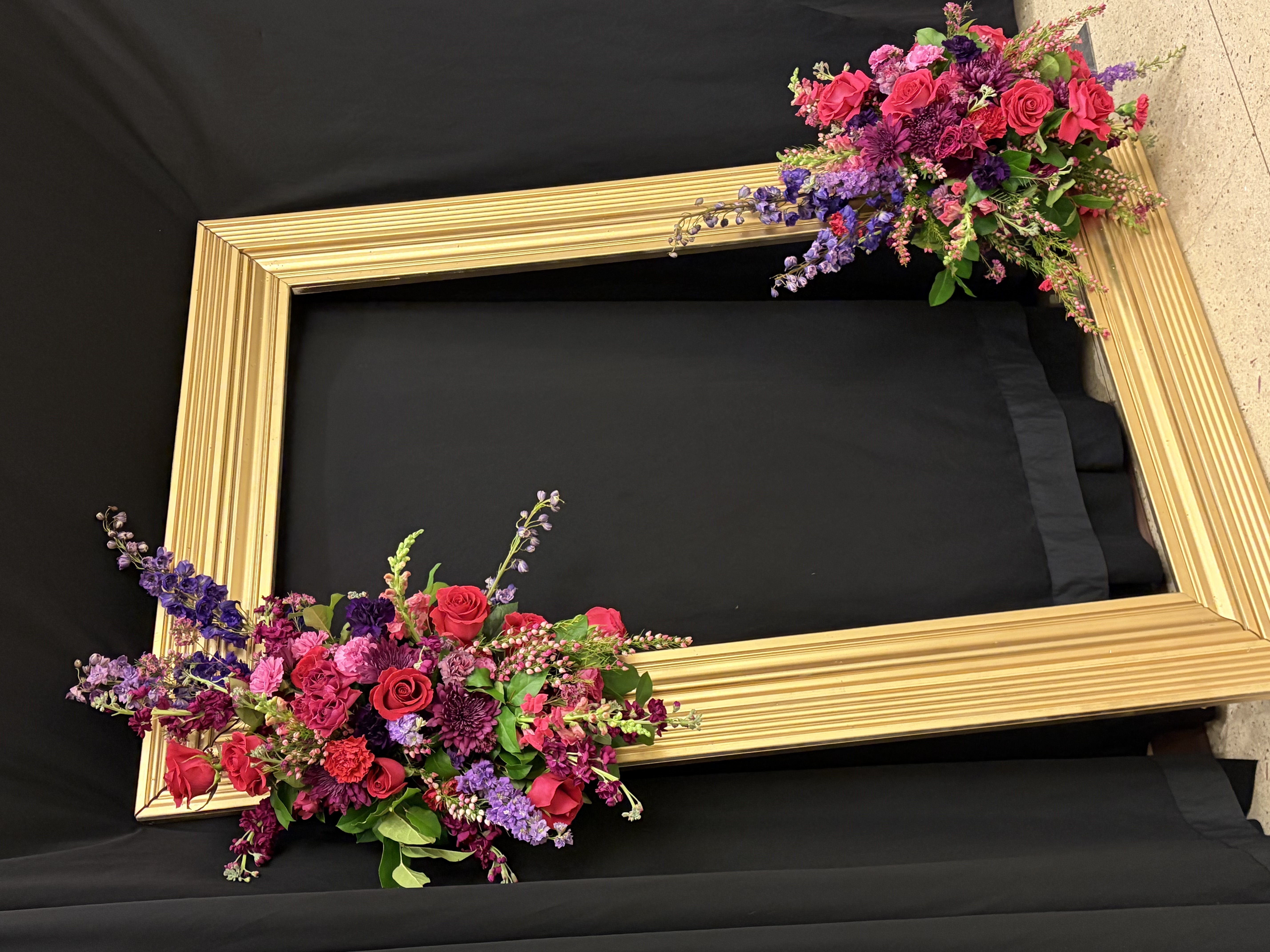 Gold picture frame with flower installation accents